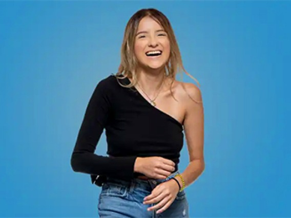Female student smiling with a light blue background